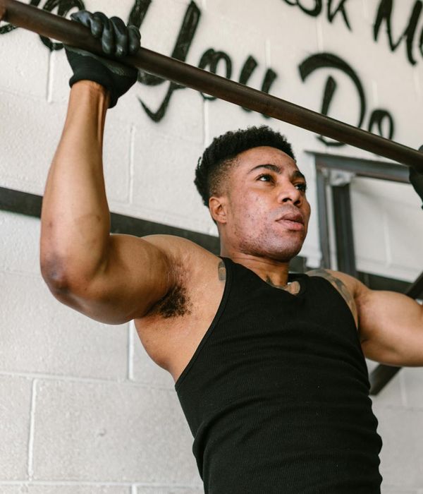 Man performing a core strength exercise in a modern gym.
